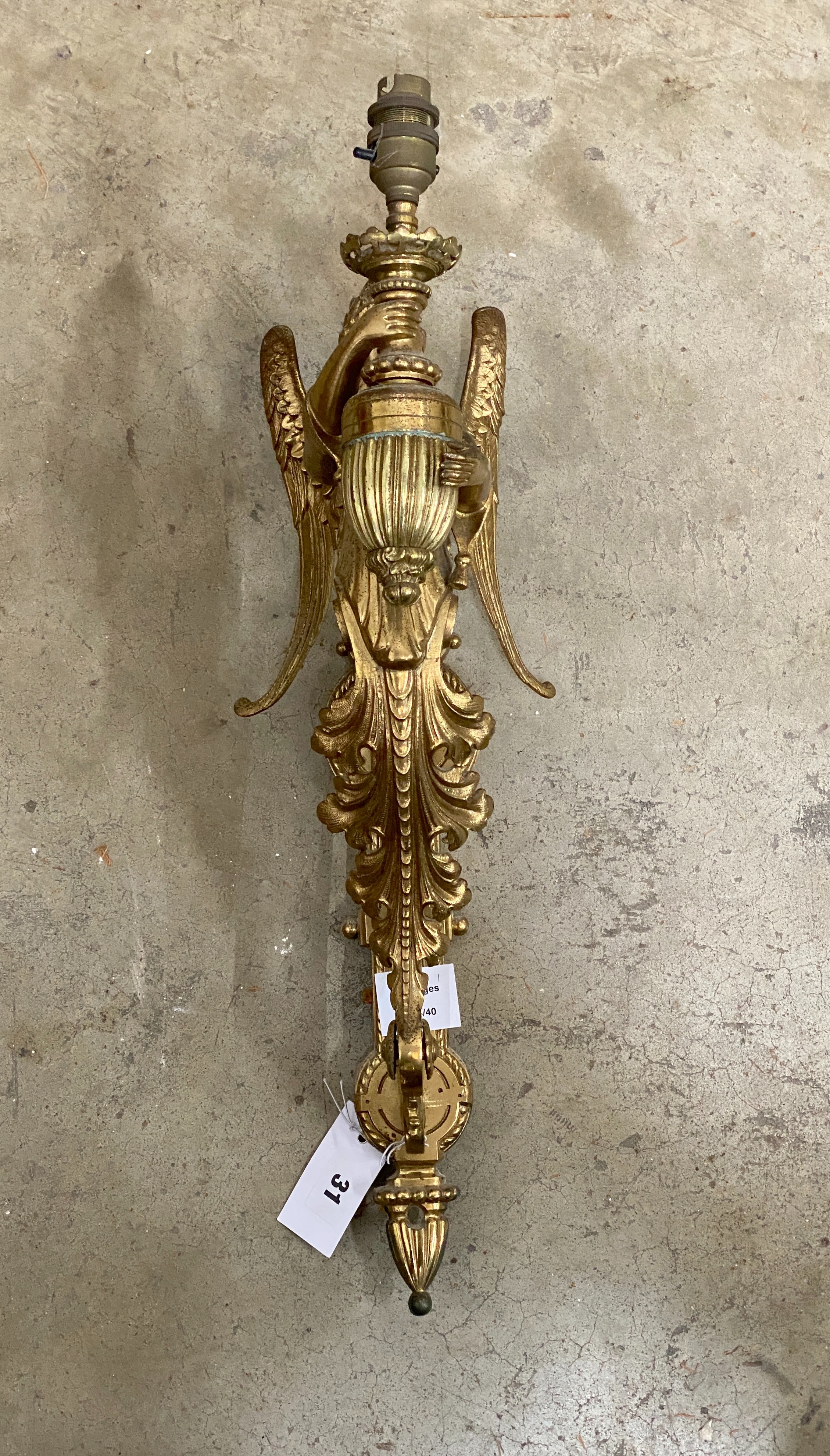 A brass single caryatid wall light, height 50cm